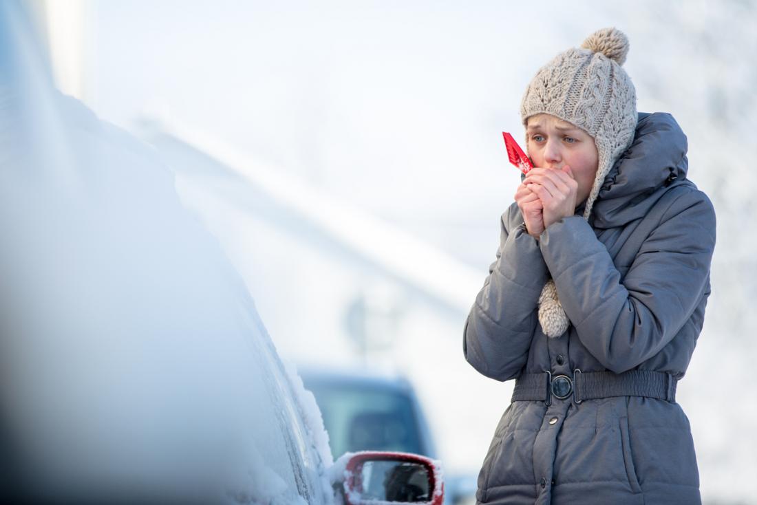 Cold woman warming hands.