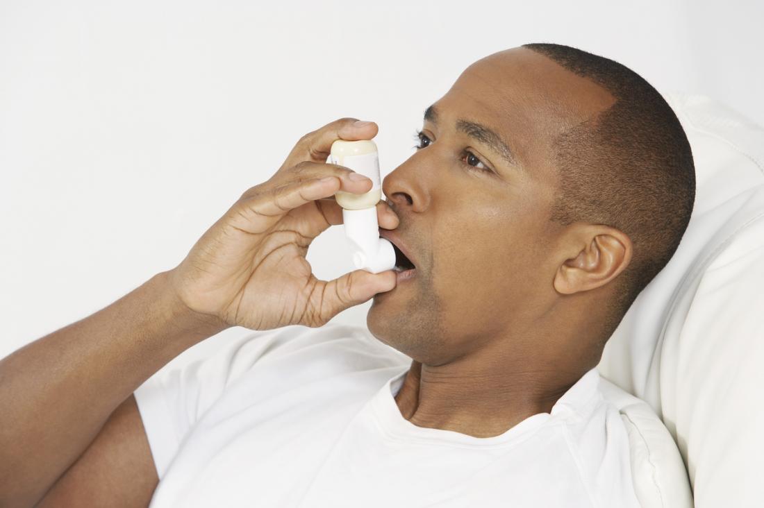 Man with asthma inhaler.