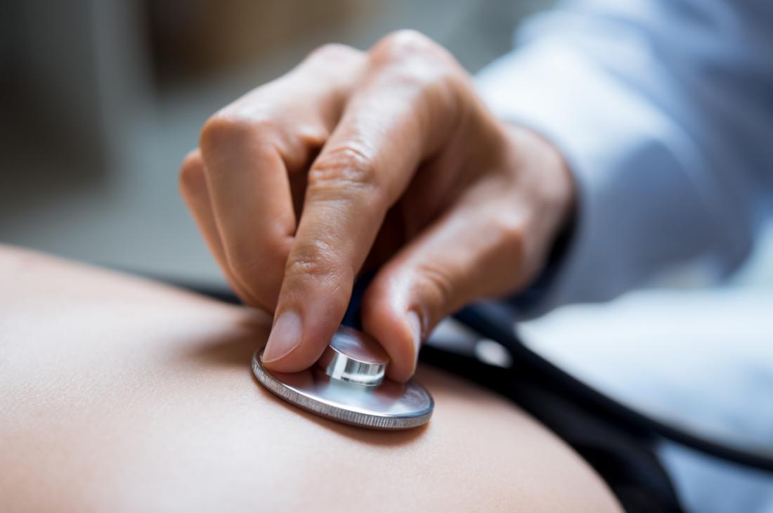 Doctor listening to patient's breathing.