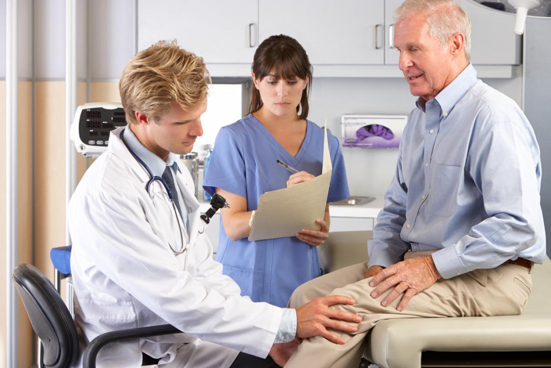 doctor examining older patient