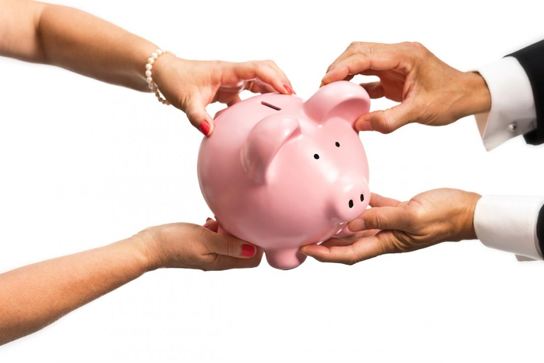 spouses trying to grab piggy bank from each other