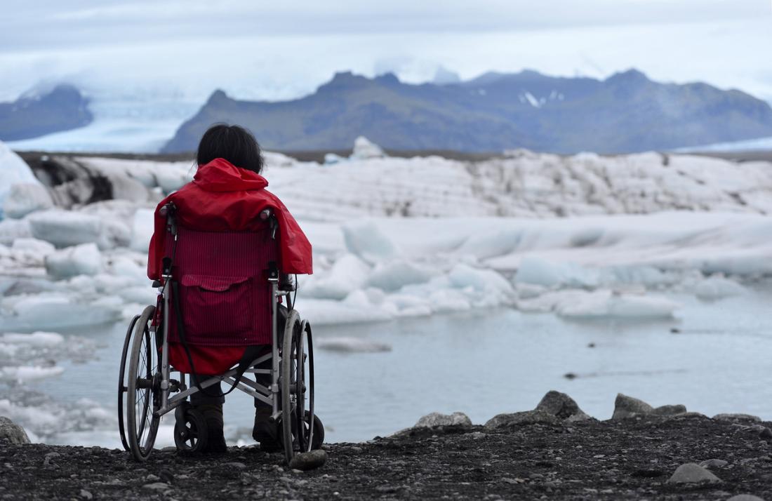 woman in wheelchair staring at ice