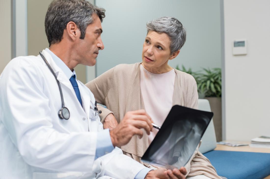 doctor explaining x ray to senior patient
