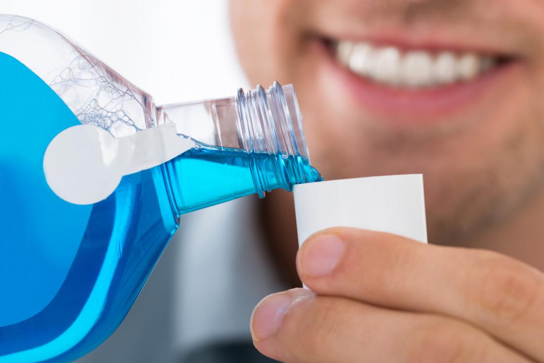 Mouthwash being poured into cap