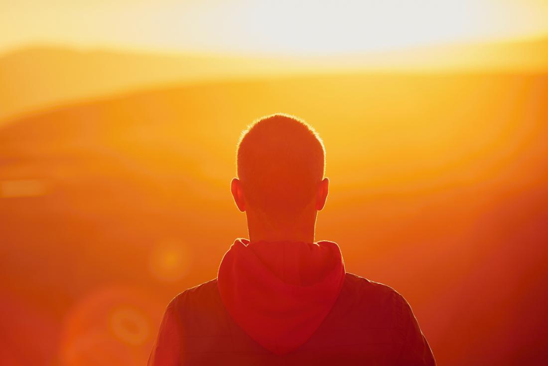man looking into the distance at sunrise