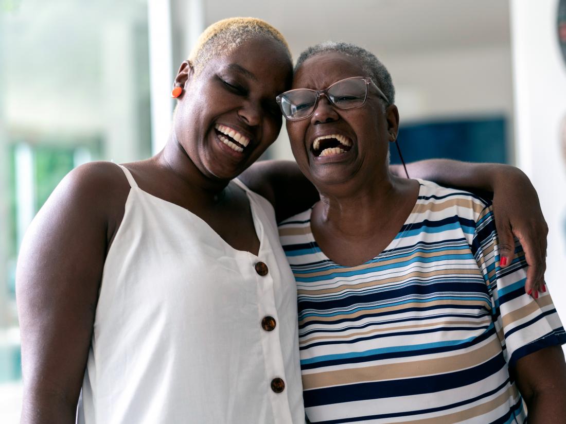 a mother and daughter smiling.
