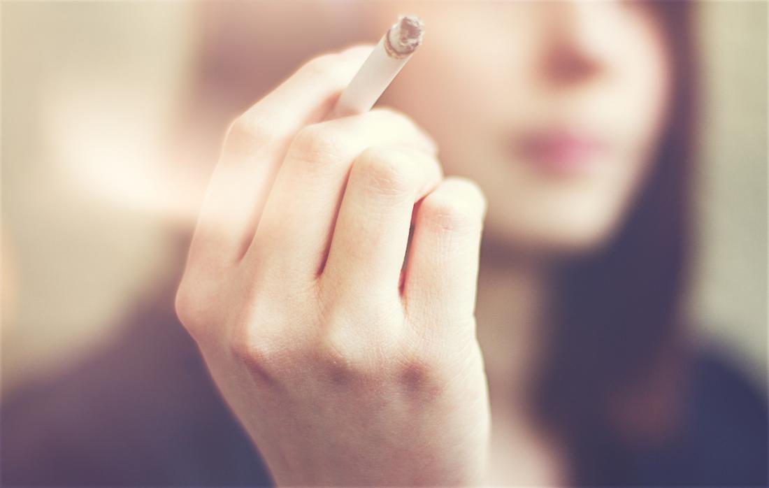 Woman holding a cigarette.