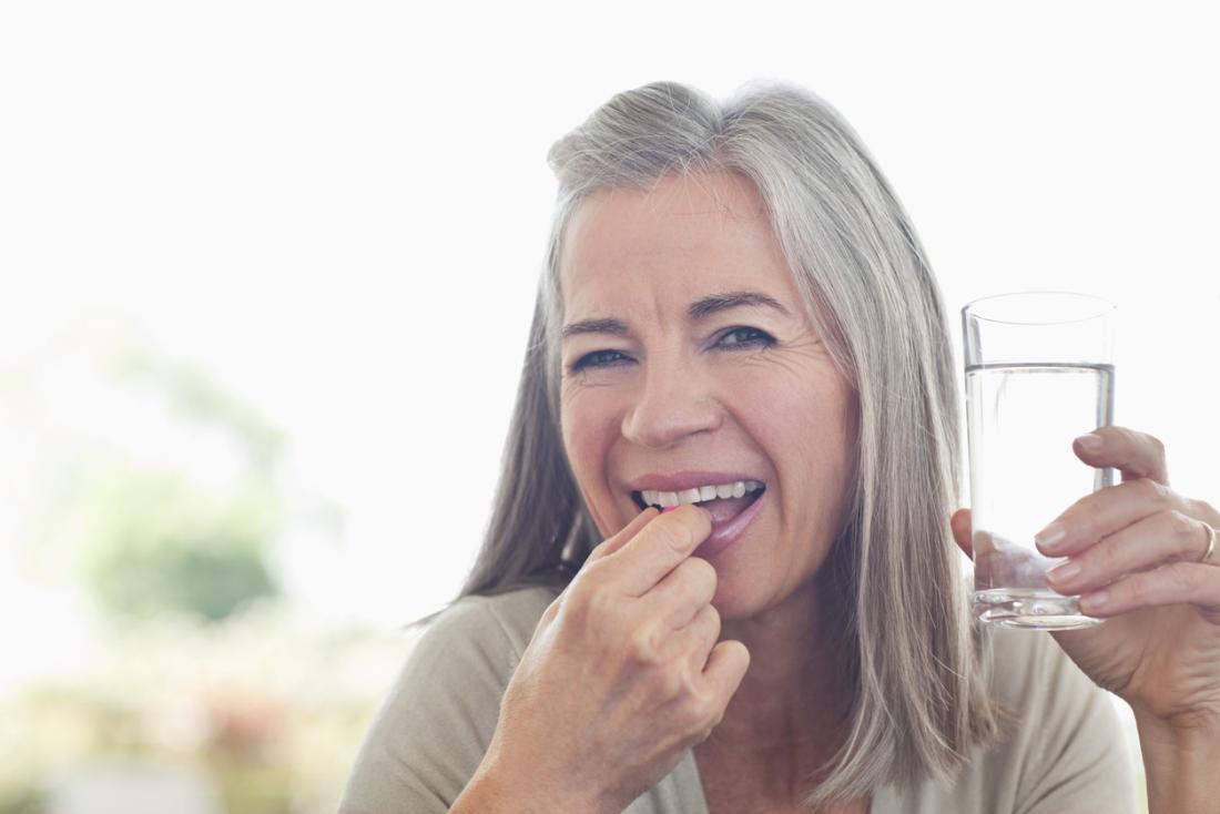 Older lady taking pill