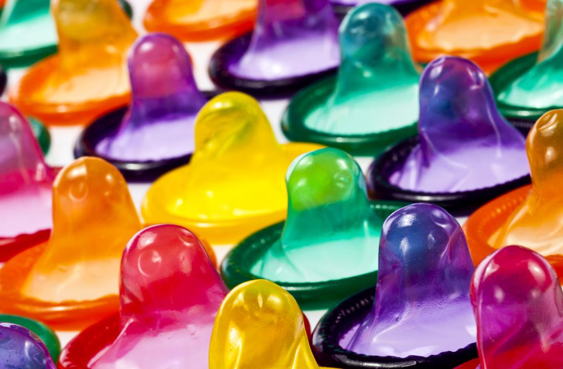 Various colored condoms lined up.
