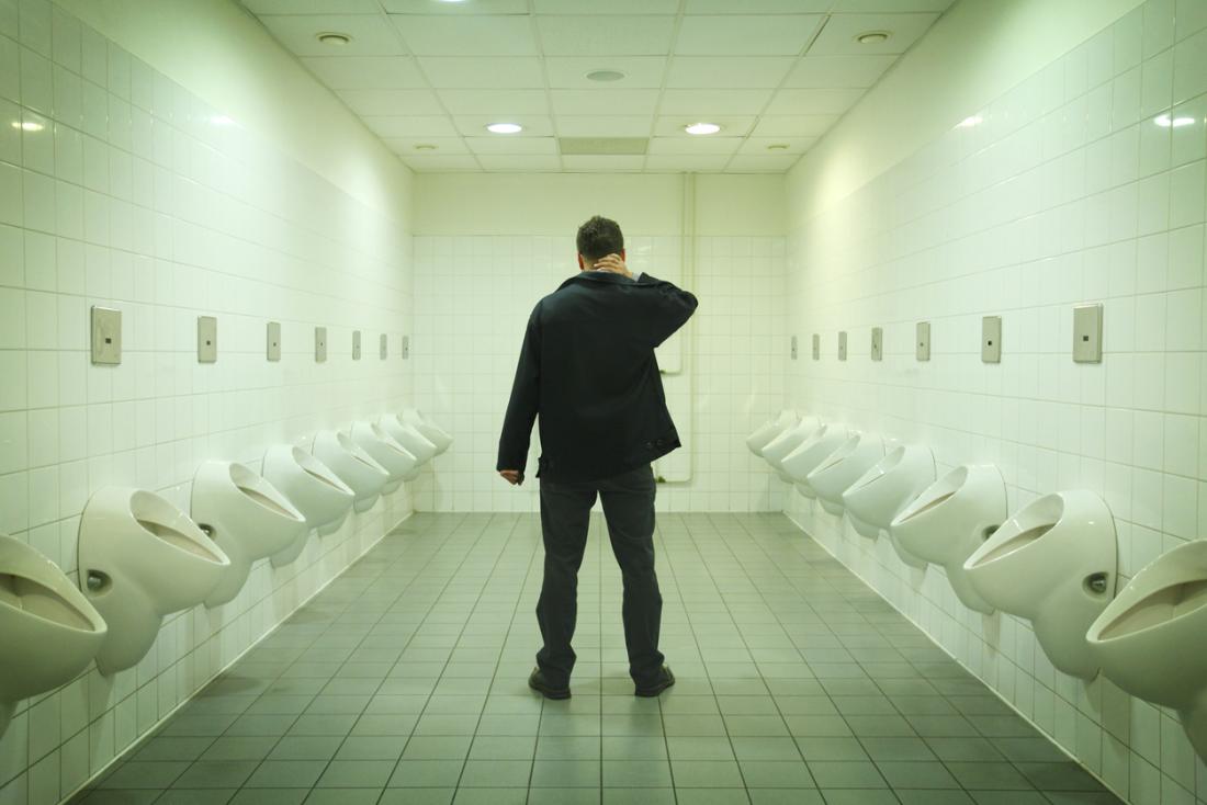man in urinal