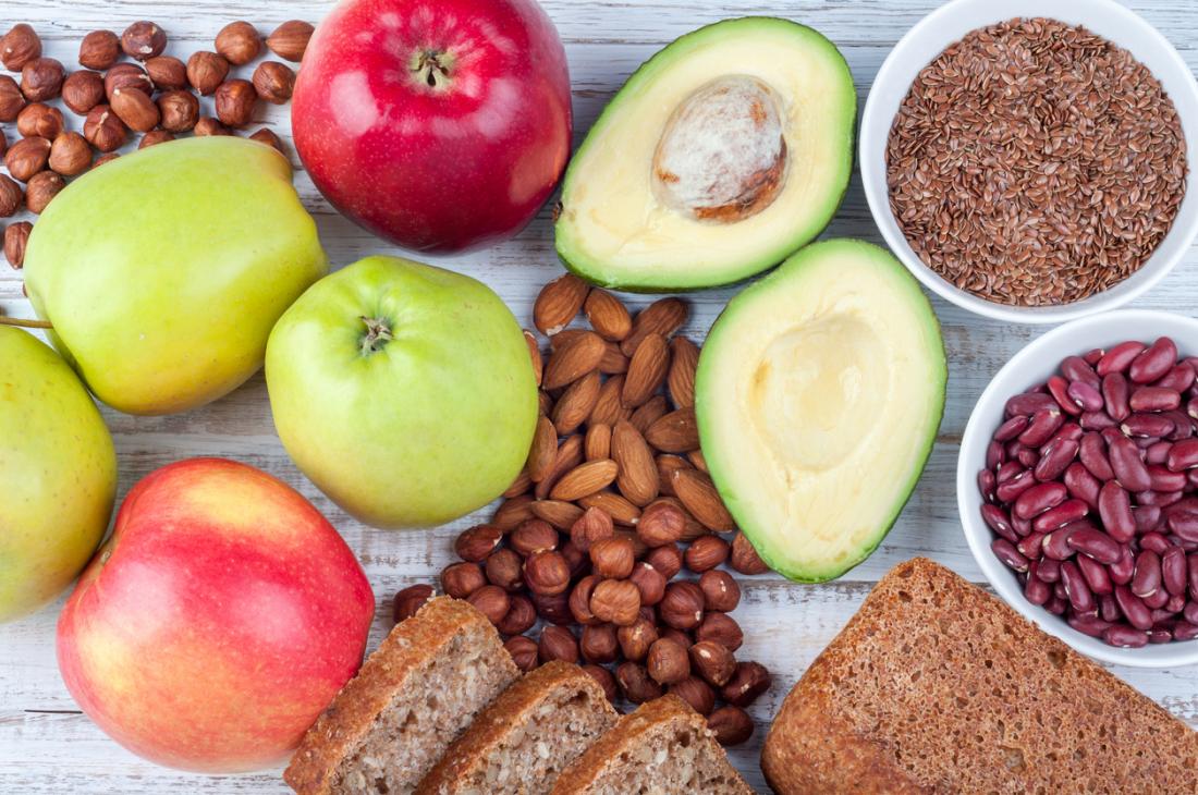 Healthy Plant Foods That Are Sources Of Fibre Including Avocadoes Nuts Seeds Apples Legumes And Whole Grains 