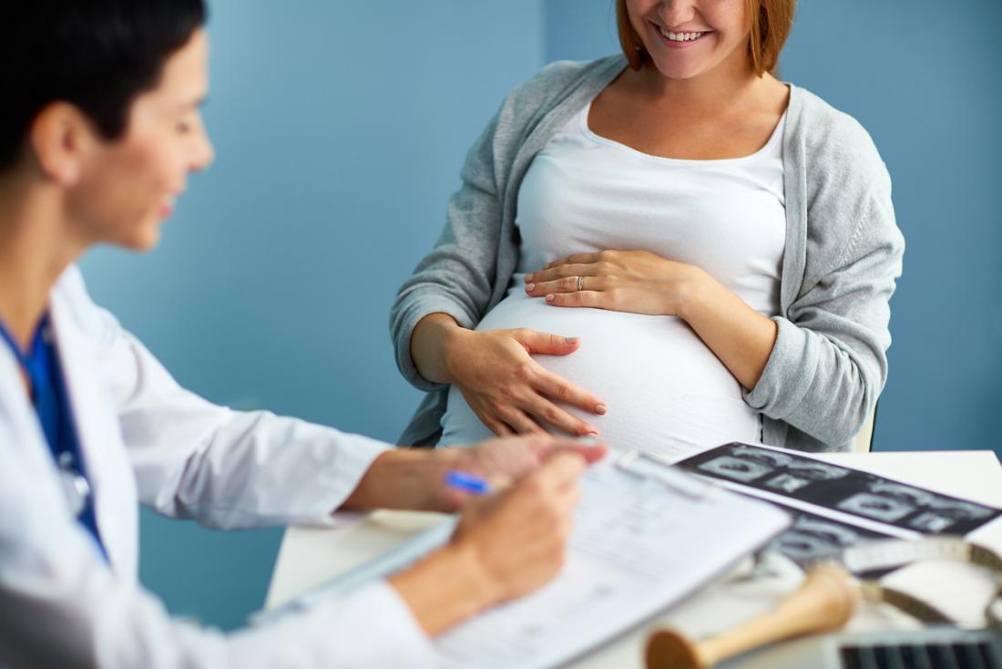 Pregnant lady speaking to a doctor