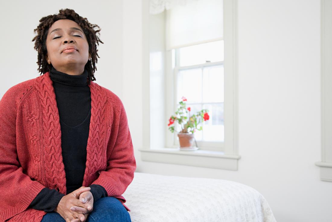 woman calm breathing on her bed