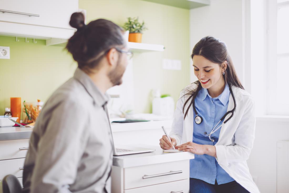 doctor writing out a prescription for a patient