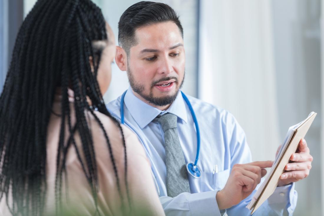 Young male doctor discussing results with female patient.