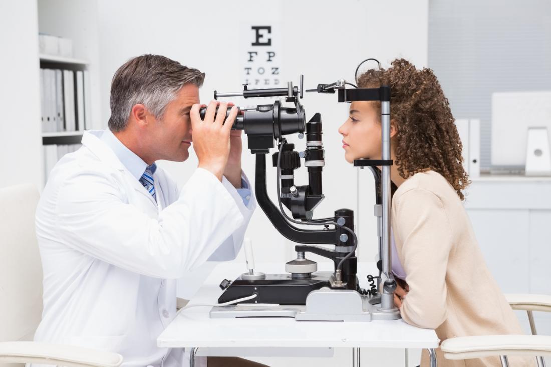 Woman having eye vision test at opticians.