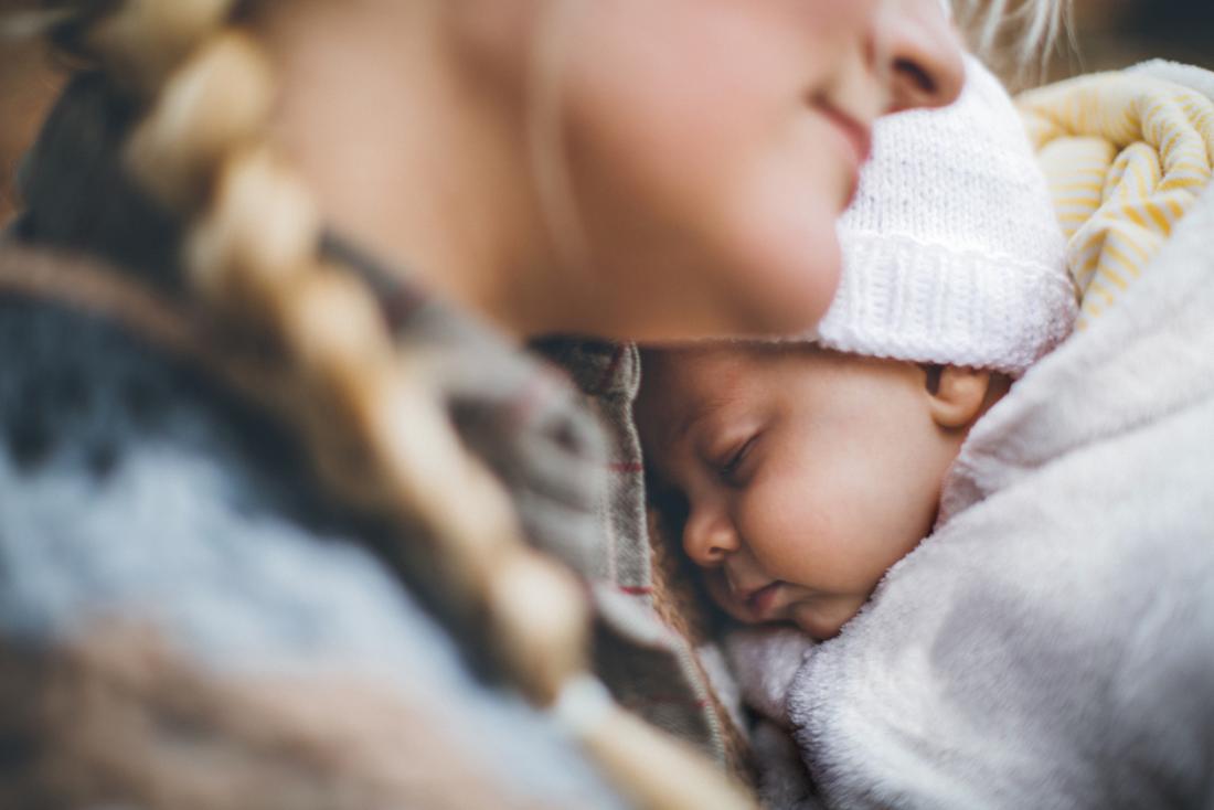 a woman hugging her baby