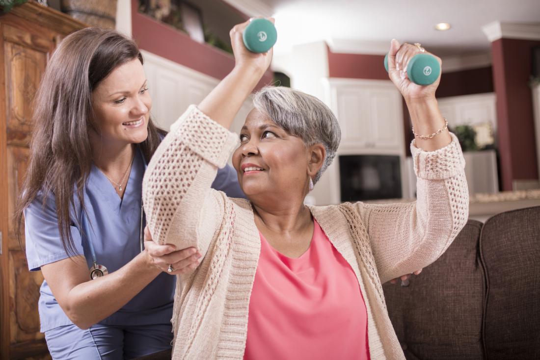 Older lady doing exercise with her nurse