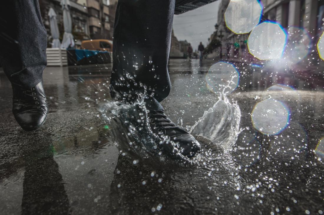 man walking in a puddle, risk factor for blisters