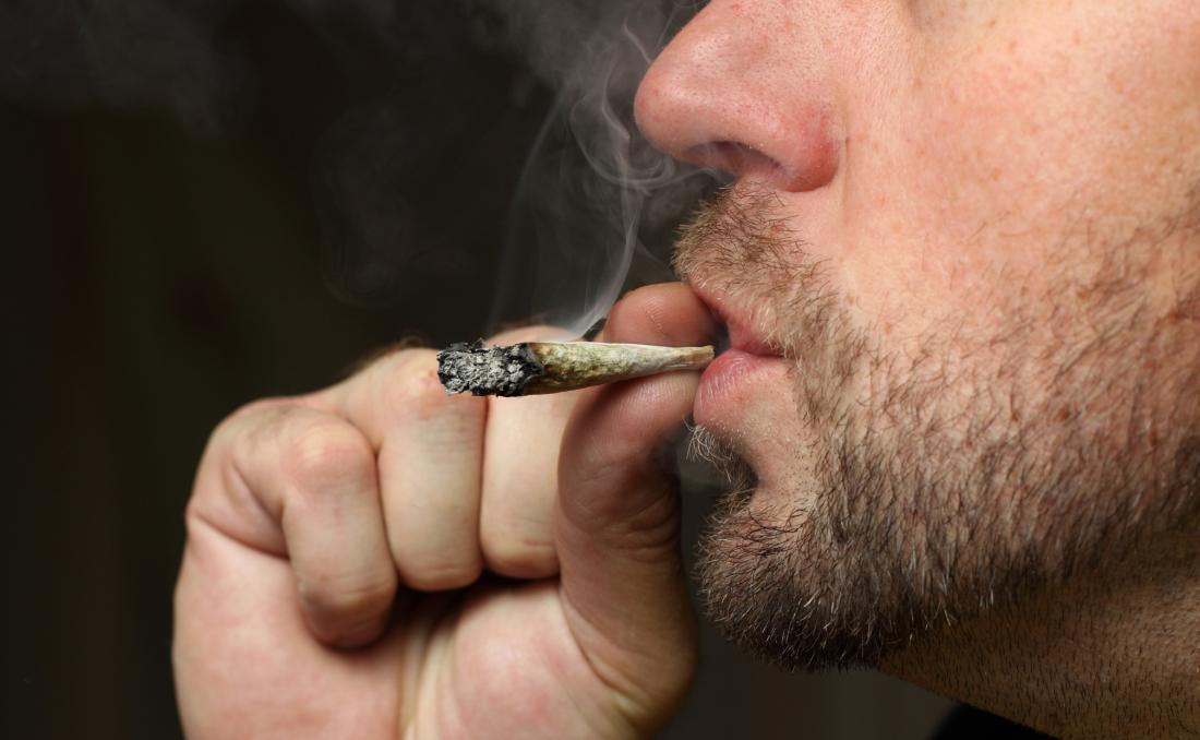 young man smoking cannabis