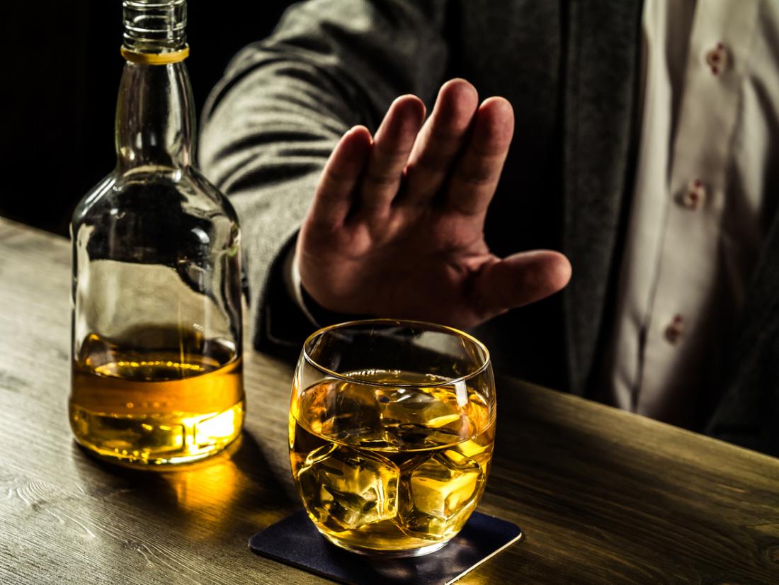 man turning down whisky