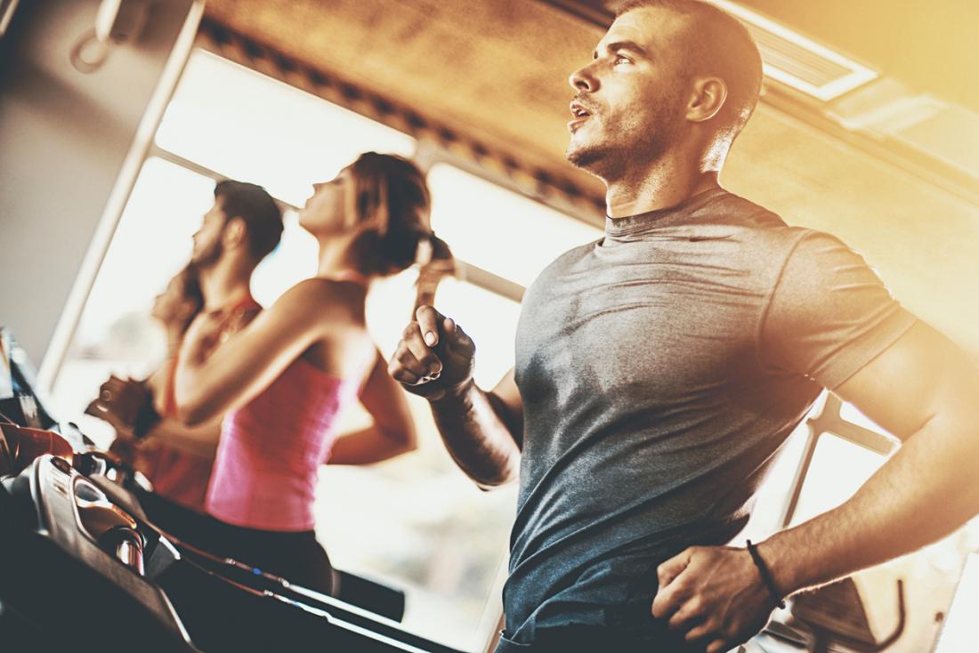 Man exercising on treadmill in gym.