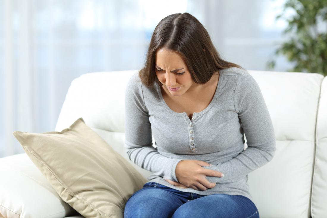 Woman holding her stomach in pain.