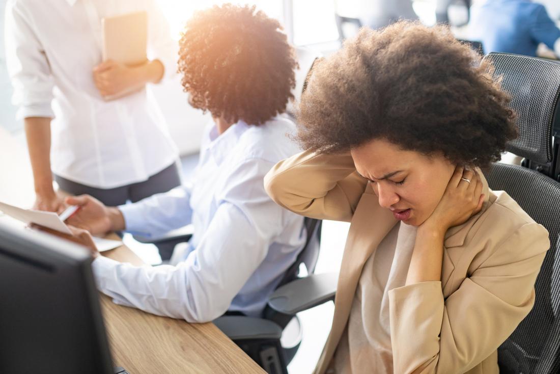 woman with headache in office