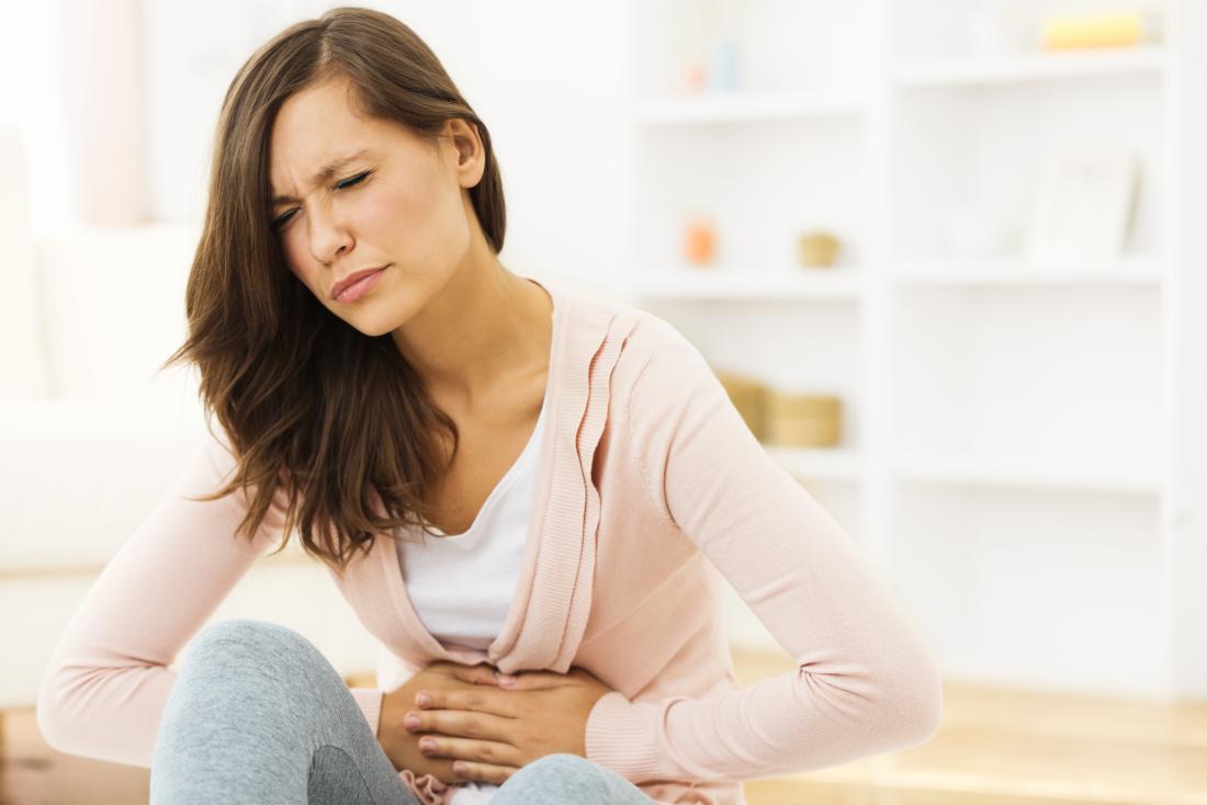 woman holding her stomach in pain