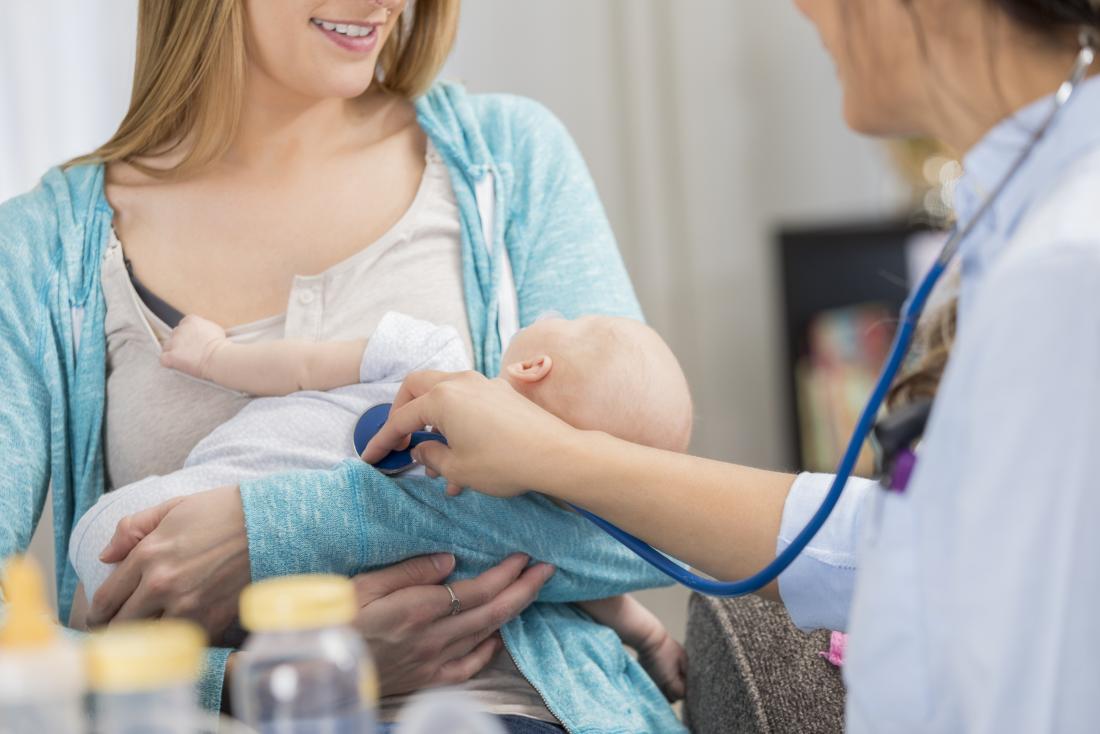 Baby being checked by doctor