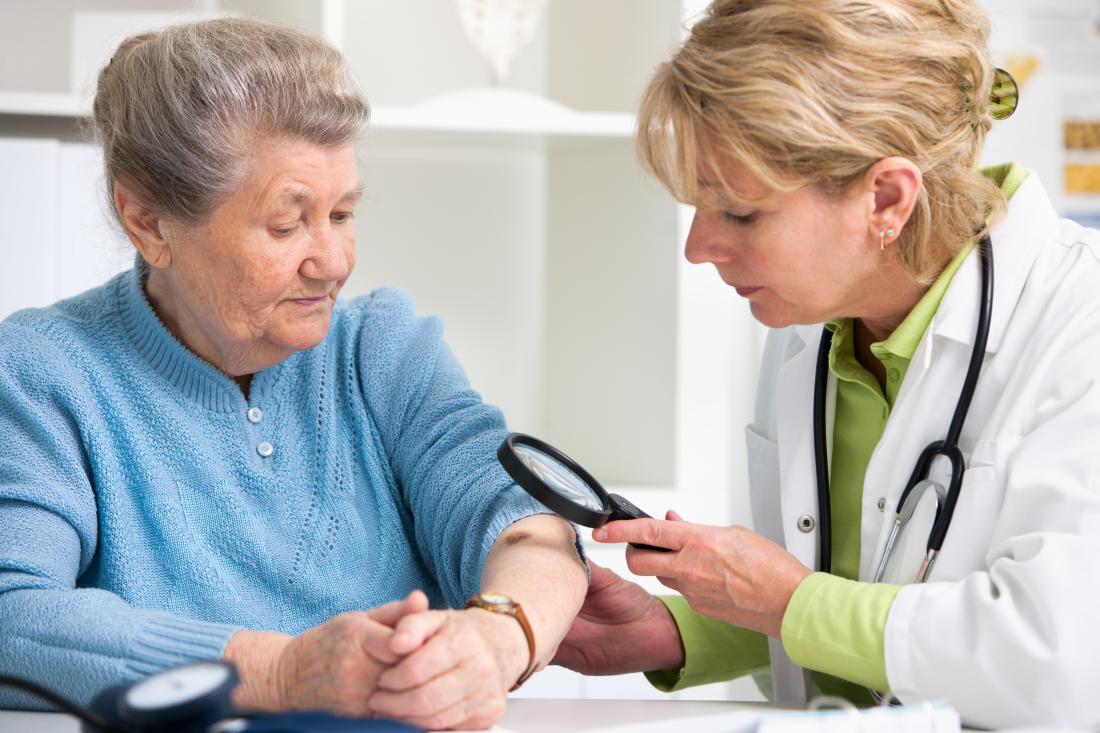 elderly woman has her skin examined for cancer