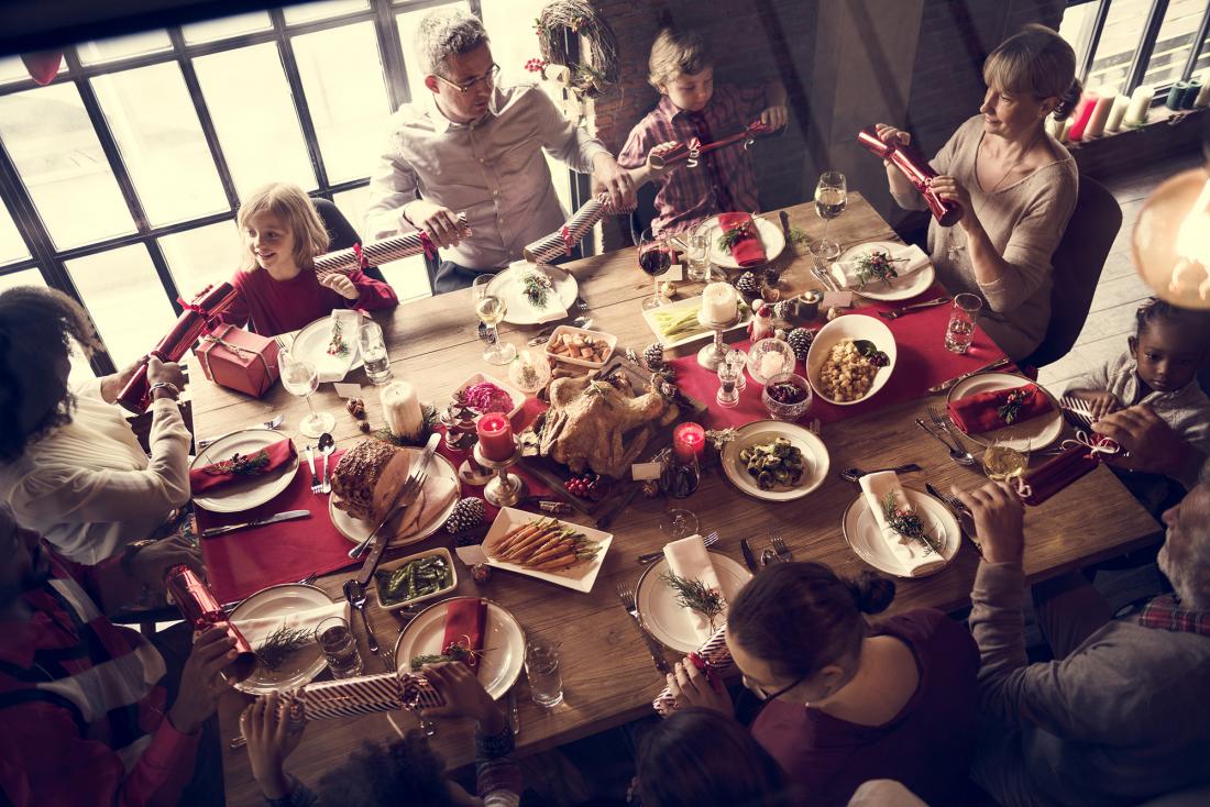 family sitting at the table with Christmas dinner