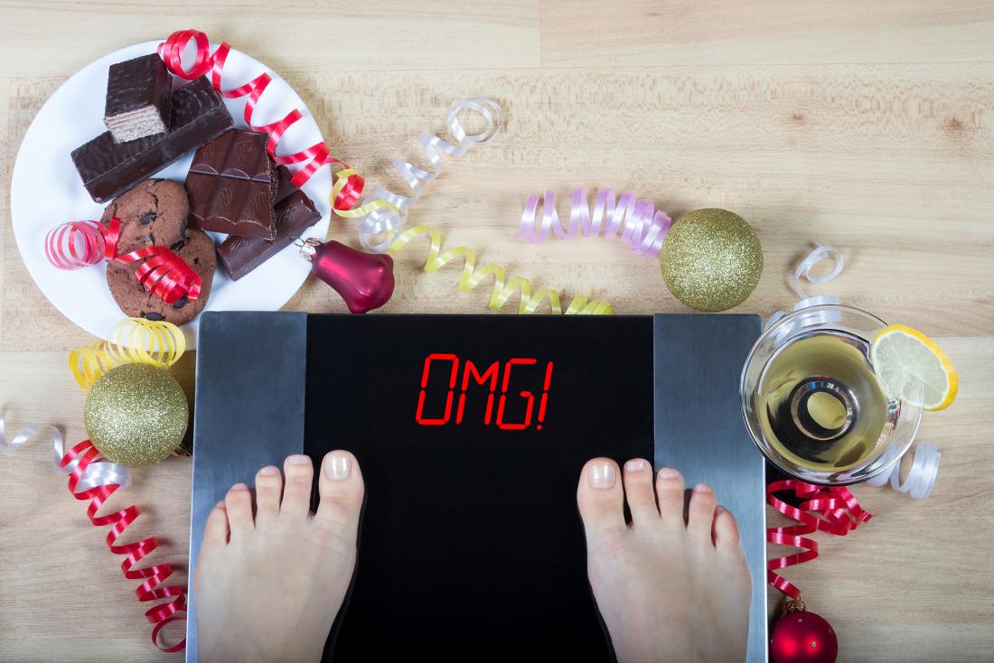 person standing on the scales after eating Christmas food
