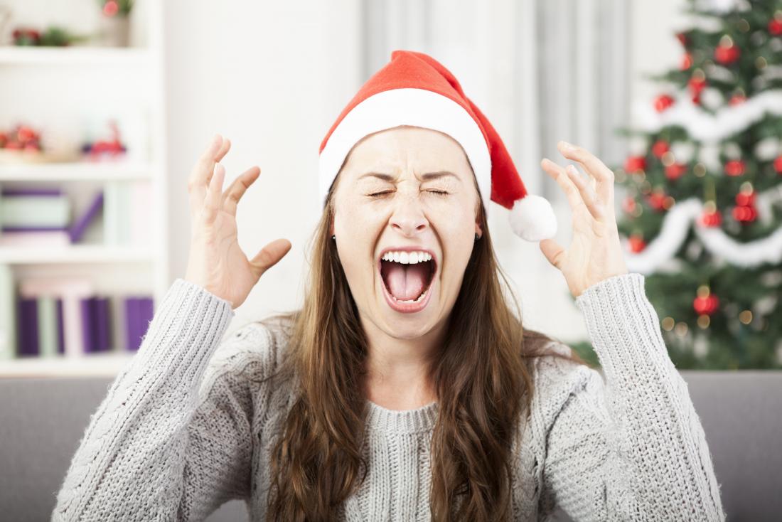 stressed woman wearing christmas hat