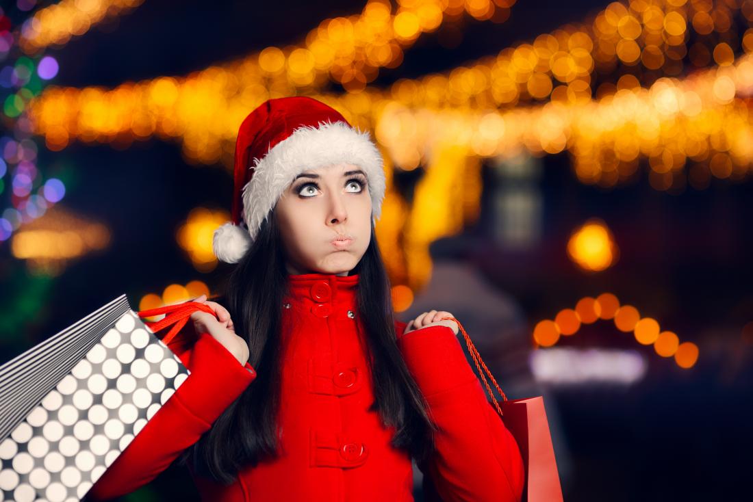 woman wearing Christmas hat and shopping