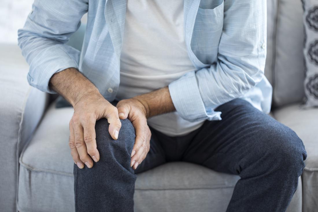 person holding knee in pain