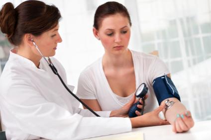 young woman getting blood pressure read