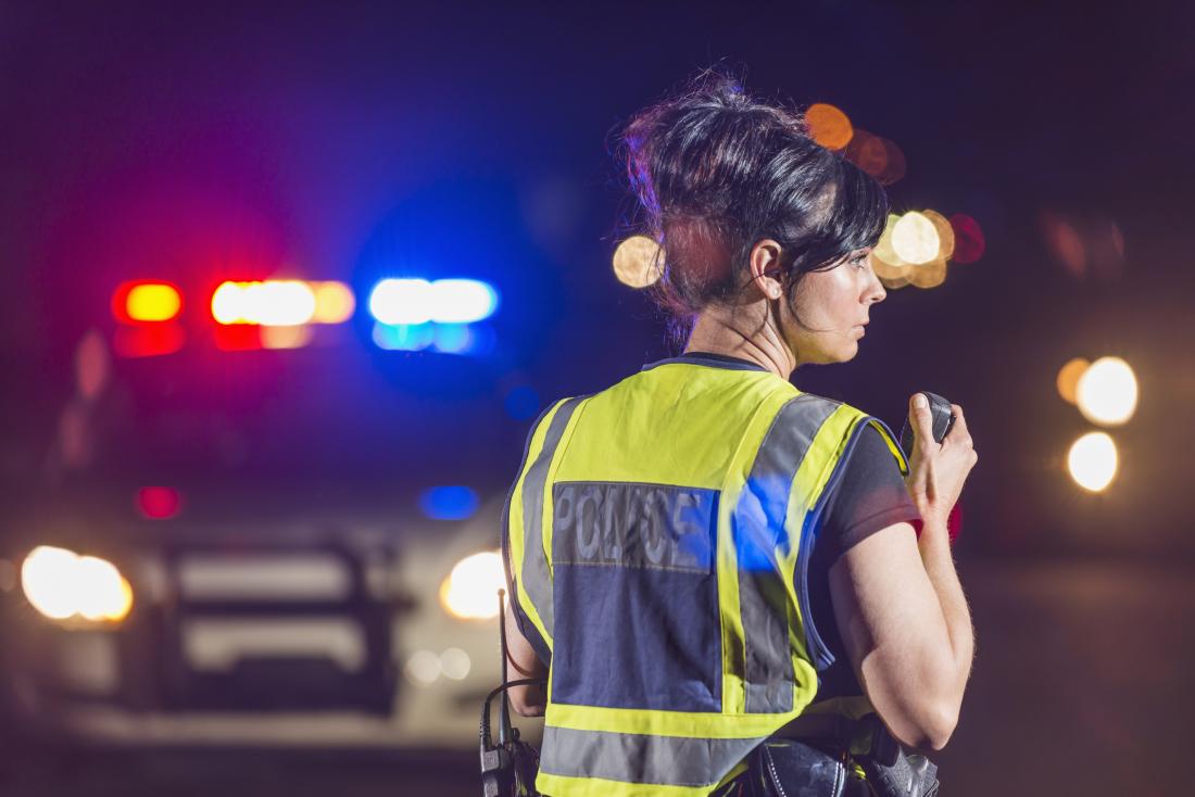 Female police officer at emergency site.