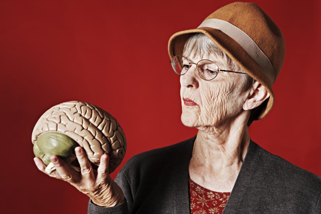 Older adult looking at a brain