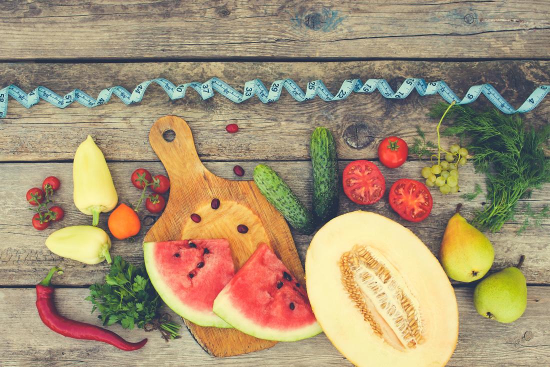 fresh fruit and vegetables with tape measure