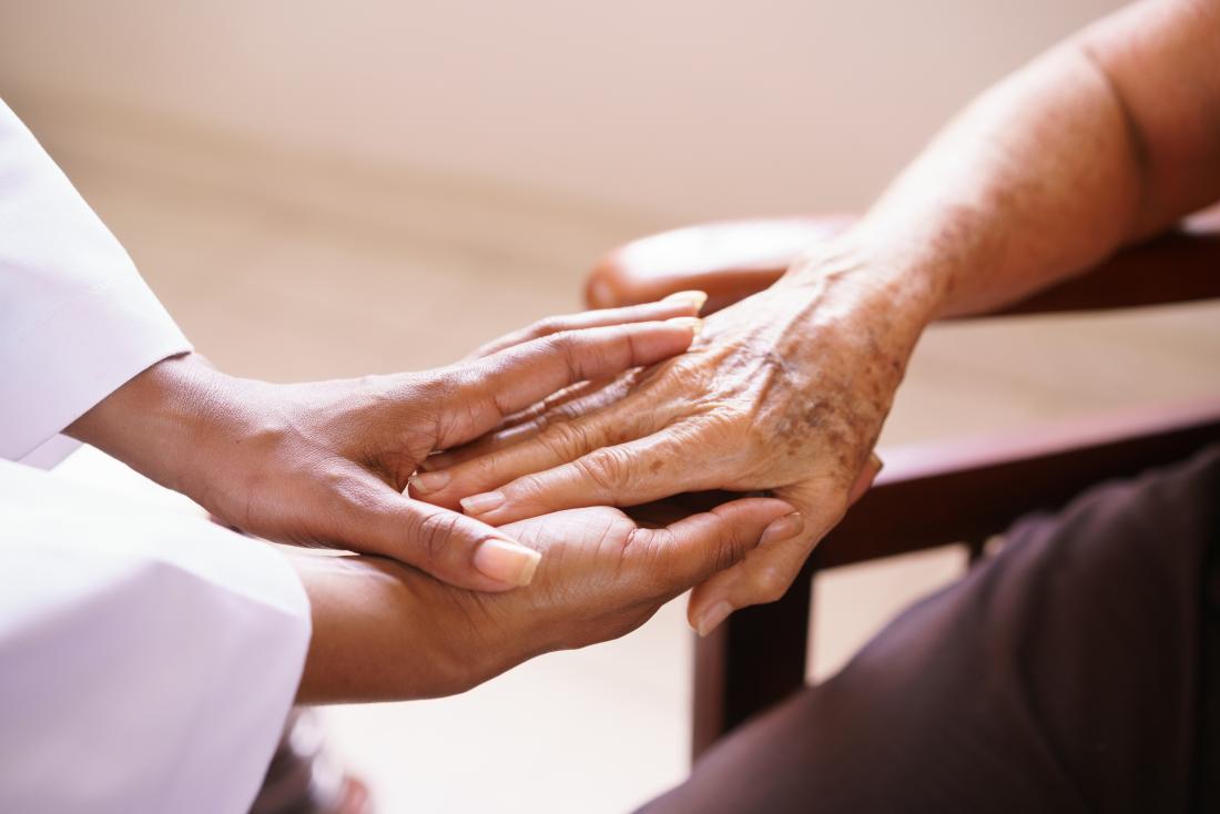 closeup of hands doctor comforting patient