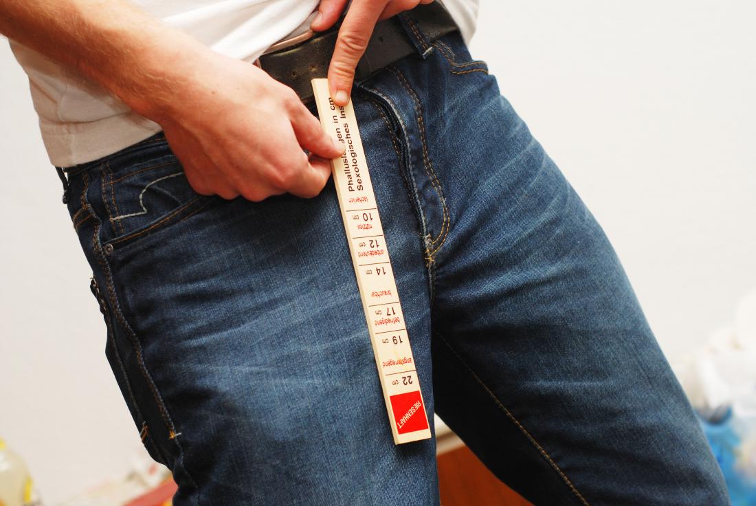 man measuring his crotch