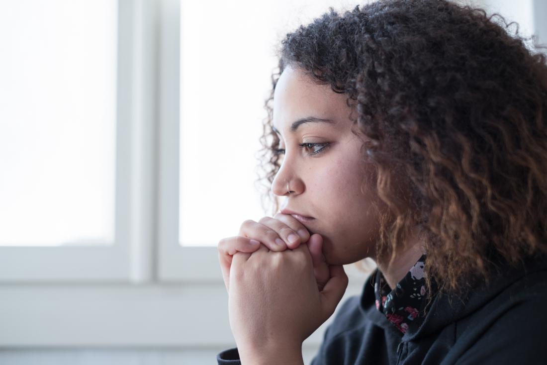 Sad and depressed woman with low dopamine levels. alone in thought.