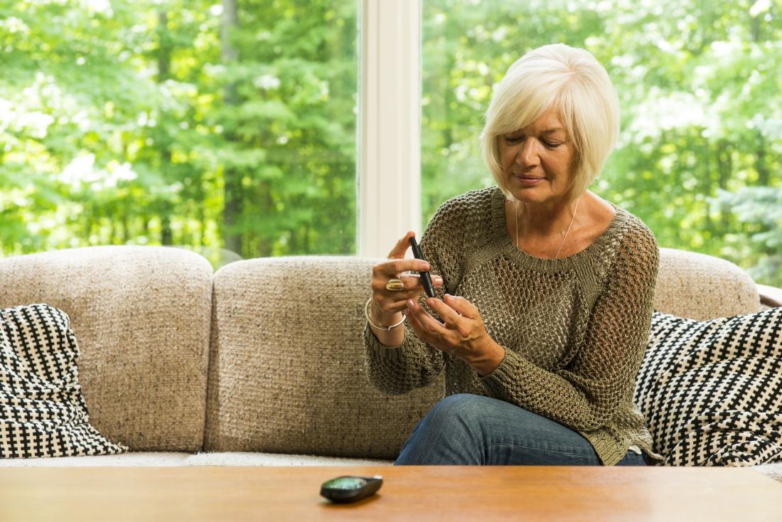 mature woman checking her blood sugar levels