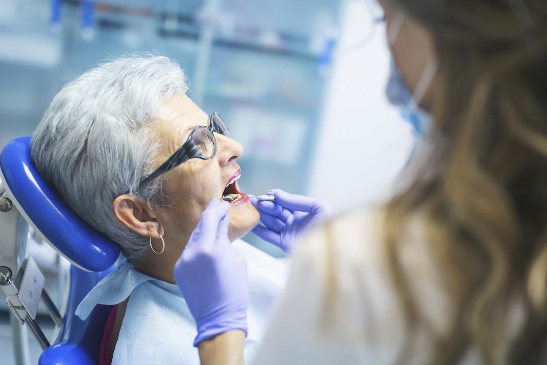 Senior woman having an oral hygiene check at the dentist.