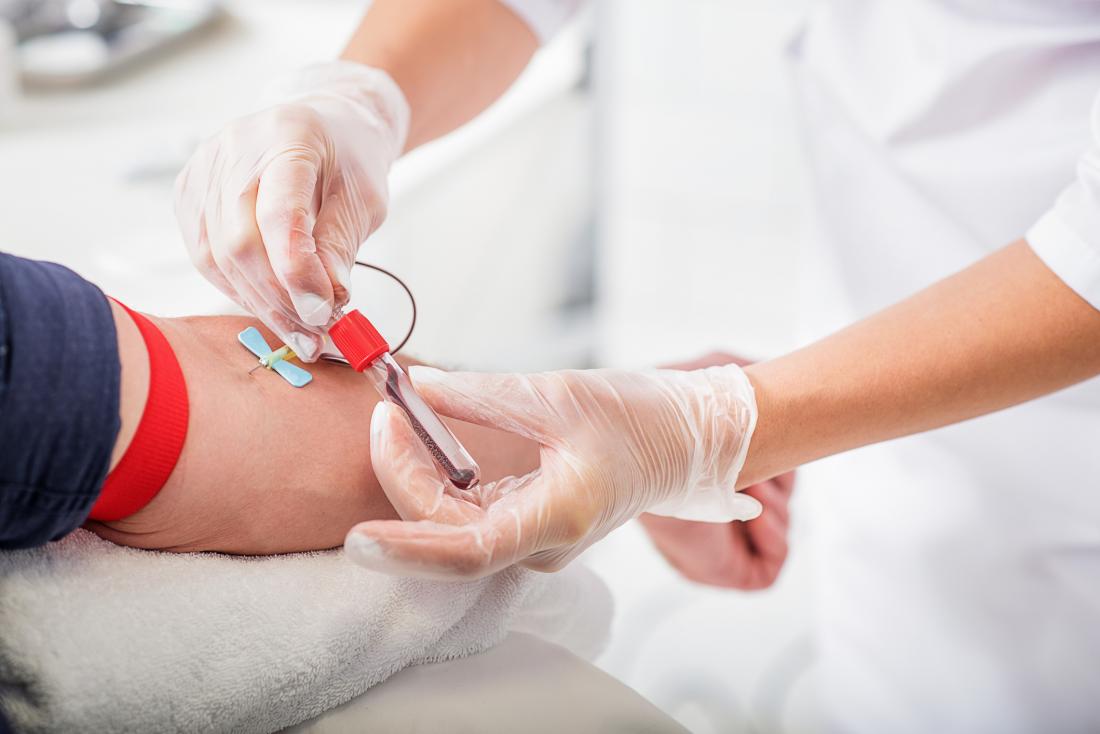 Nurse getting blood sample from patient.