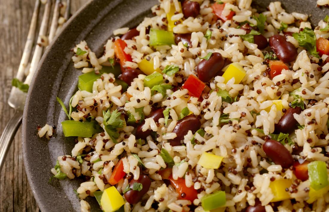 Whole grain brown rice in bowl with pulses, beans, and vegetables.