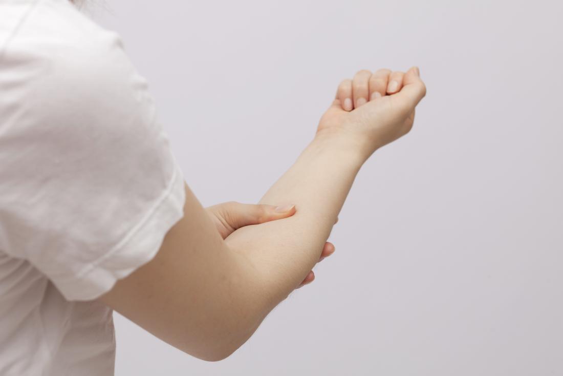 Forearm Pain Causes Exercises And Stretches   Lady Holding Forearm That May Be Causing Her Pain 