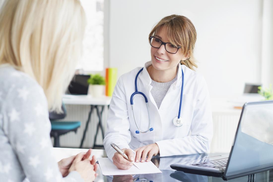 Woman in consultation with cosmetic surgeon.