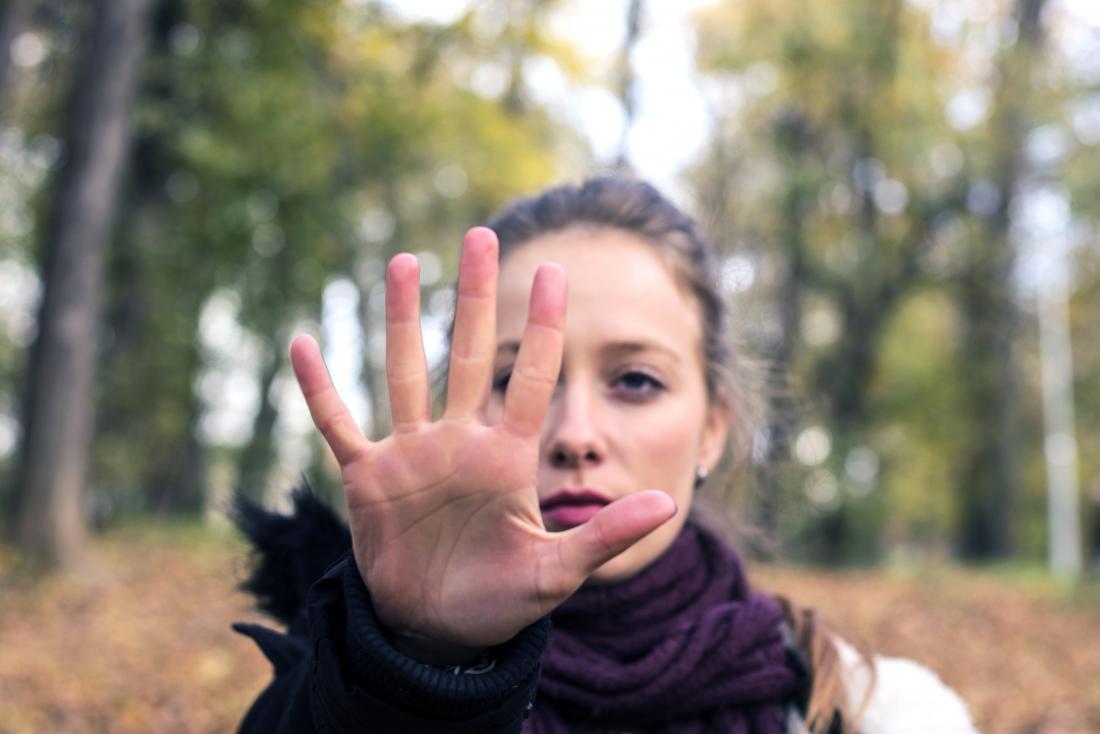 woman holding hand out indicating stop